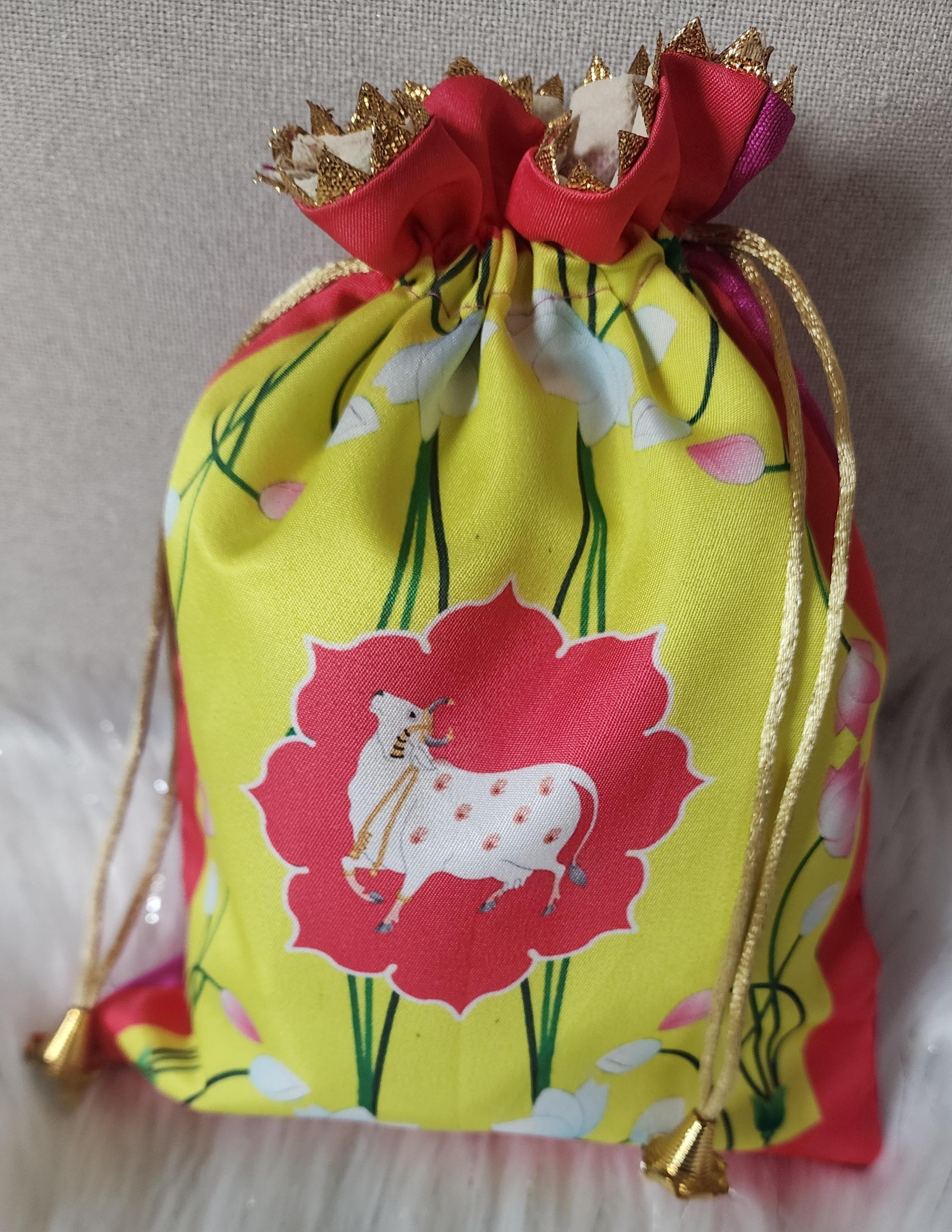 Pichwai Print Potli Bag Set: Nandi Jar & Haldi Kumkum Plate.