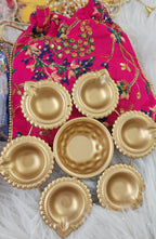 Metal Urli with 7 Diyas and Embroidered Potli Bag: Diwali Decor, 7-inch