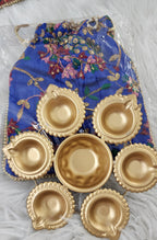 Metal Urli with 7 Diyas and Embroidered Potli Bag: Diwali Decor, 7-inch
