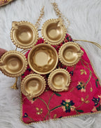 Metal Urli with 7 Diyas and Embroidered Potli Bag: Diwali Decor, 7-inch