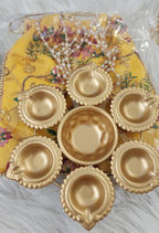 Metal Urli with 7 Diyas and Embroidered Potli Bag: Diwali Decor, 7-inch